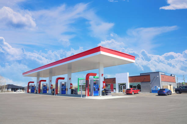 Modern Service Station with convenience store and a few cars, in a Sunny Day